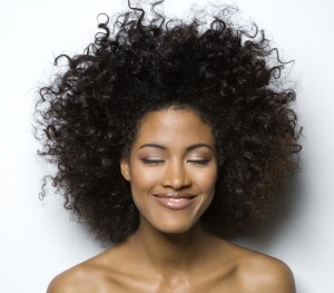 Young woman with eyes closed, smiling, close-up