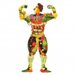 Fruits and vegetables in the shape of a healthy posing muscular bodybuilder.