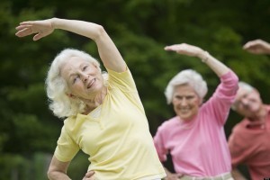 USA, New York State, Old Westbury, Seniors stretching in park