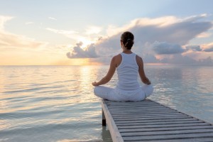 Caucasian Woman Practicing Yoga At Seashore