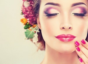 Girl with delicate flowers in hair and fashion fuchsia nail