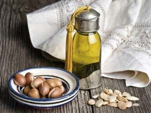 Bottle of argan oil and argan fruit. Argan oil is used for skincare products.