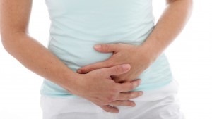Cropped view of the hands of a woman with stomach pain clutching her stomach, isolated on white; Shutterstock ID 136757459; PO: today.com