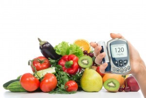 Diabetes concept glucose meter in hand and healthy organic food fruits and vegetables organic green apple, egg plant, orange, tomatoes, cucumbers, parsley, kiwi, grapefruit, salad, peach, cherries on a white background