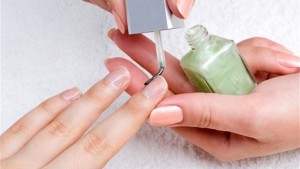 applying manicure: moisturizing the nails and skin around nails