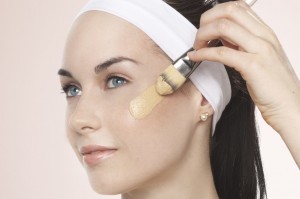 Young lady applying a swatch of foundation